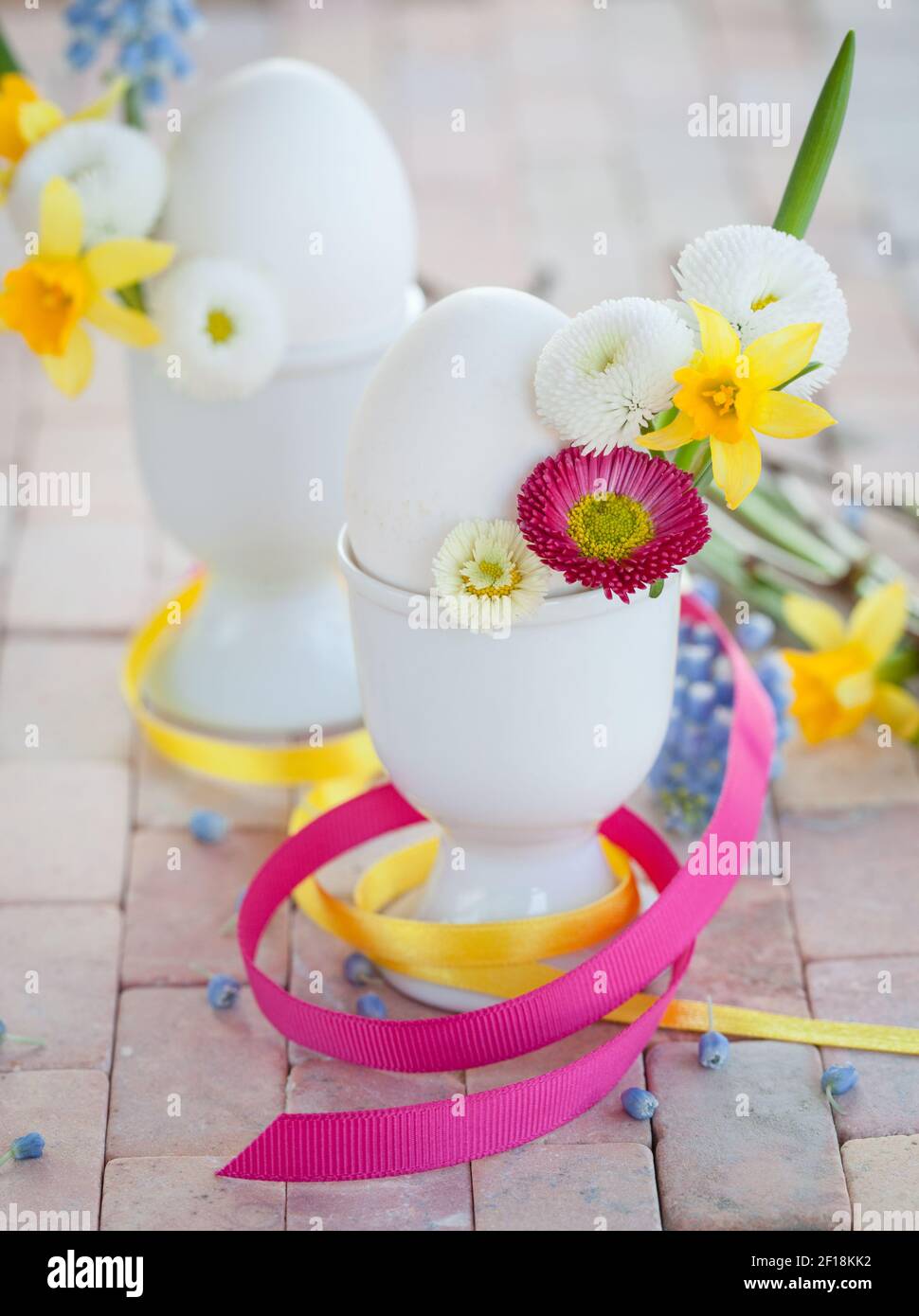 Eggs in egg cups with small flowers Stock Photo