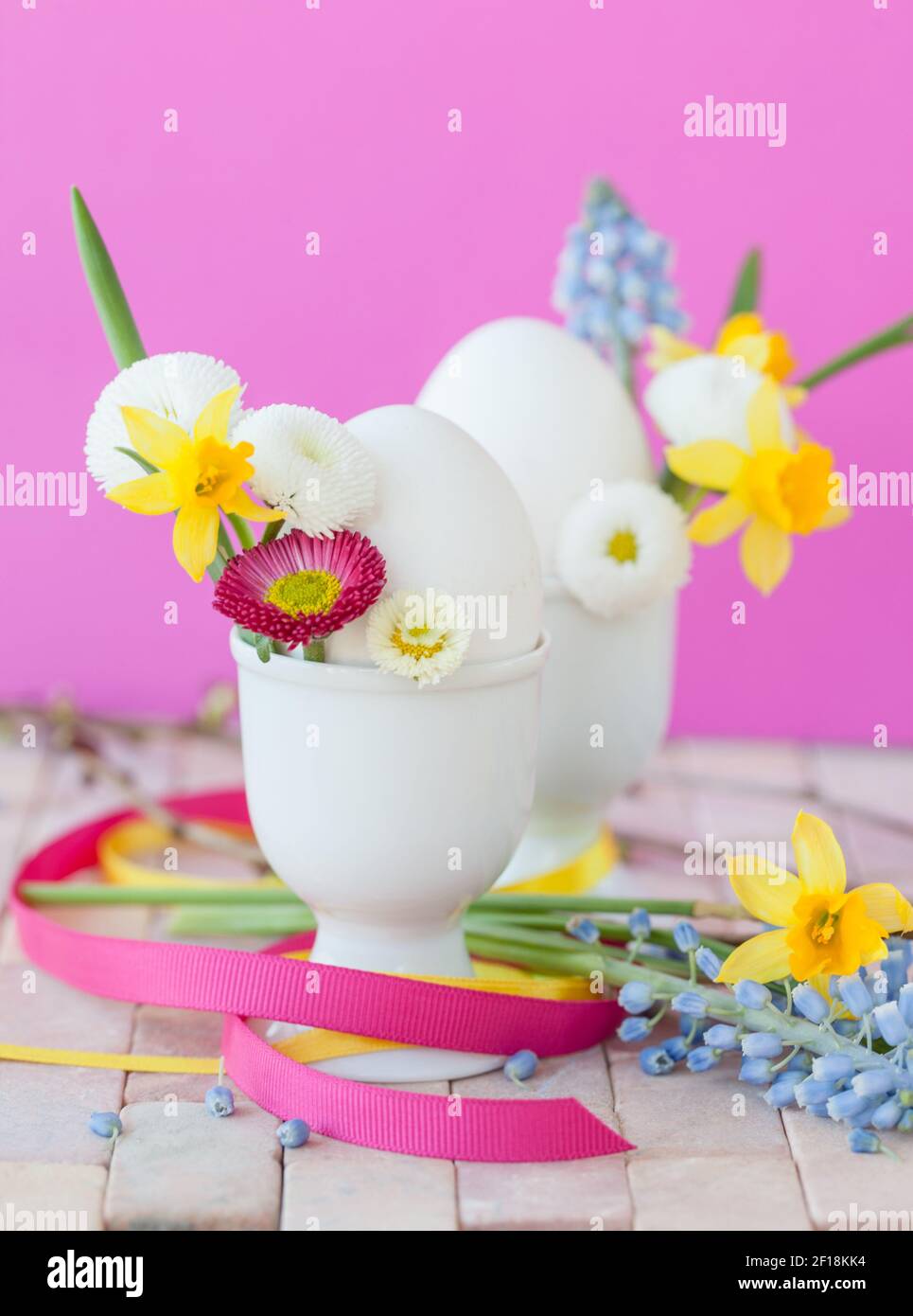 Eggs in egg cups with small flowers Stock Photo
