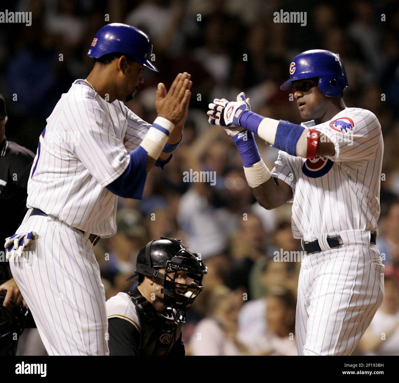 Arizona Diamondback' Roberto Alomar (2) is greeted at home plate