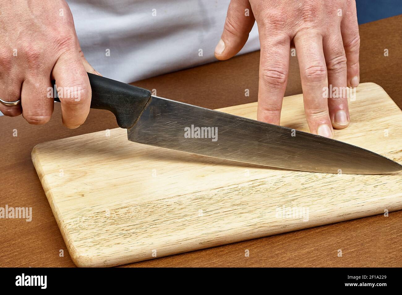 Knife in hand chef Stock Photo