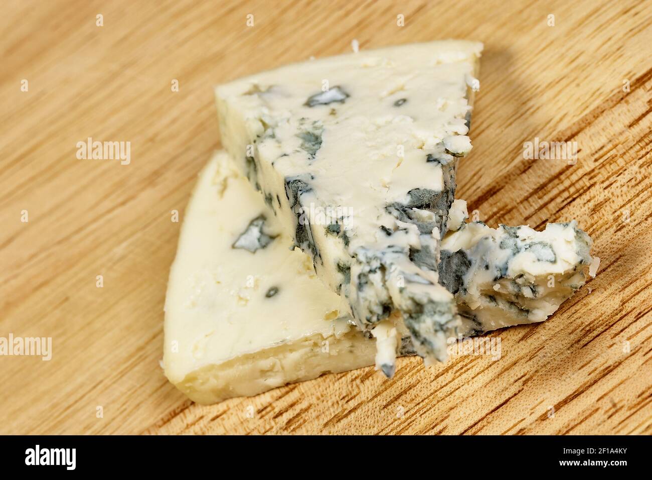 Blue cheese close up on an old wooden table horizontal macro mold Stock Photo