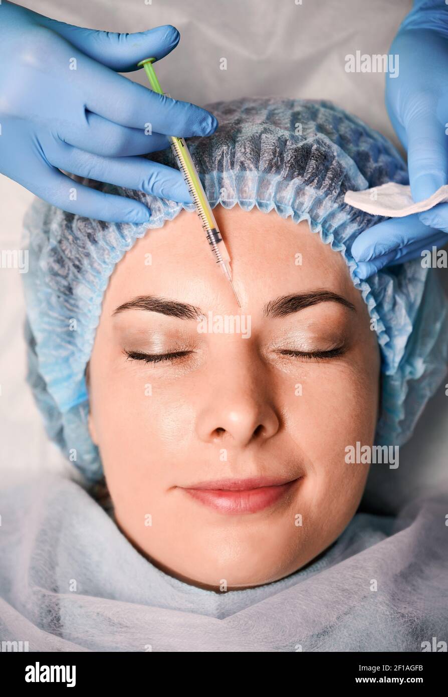 Hands cosmetologist making injection in hi res stock photography and Hands cosmetologist making injection in hi res stock photography and