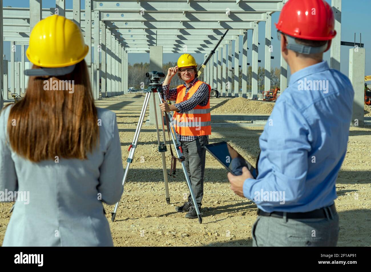 Mature Land Surveyor with Tachometer Looking at Camera. Construction