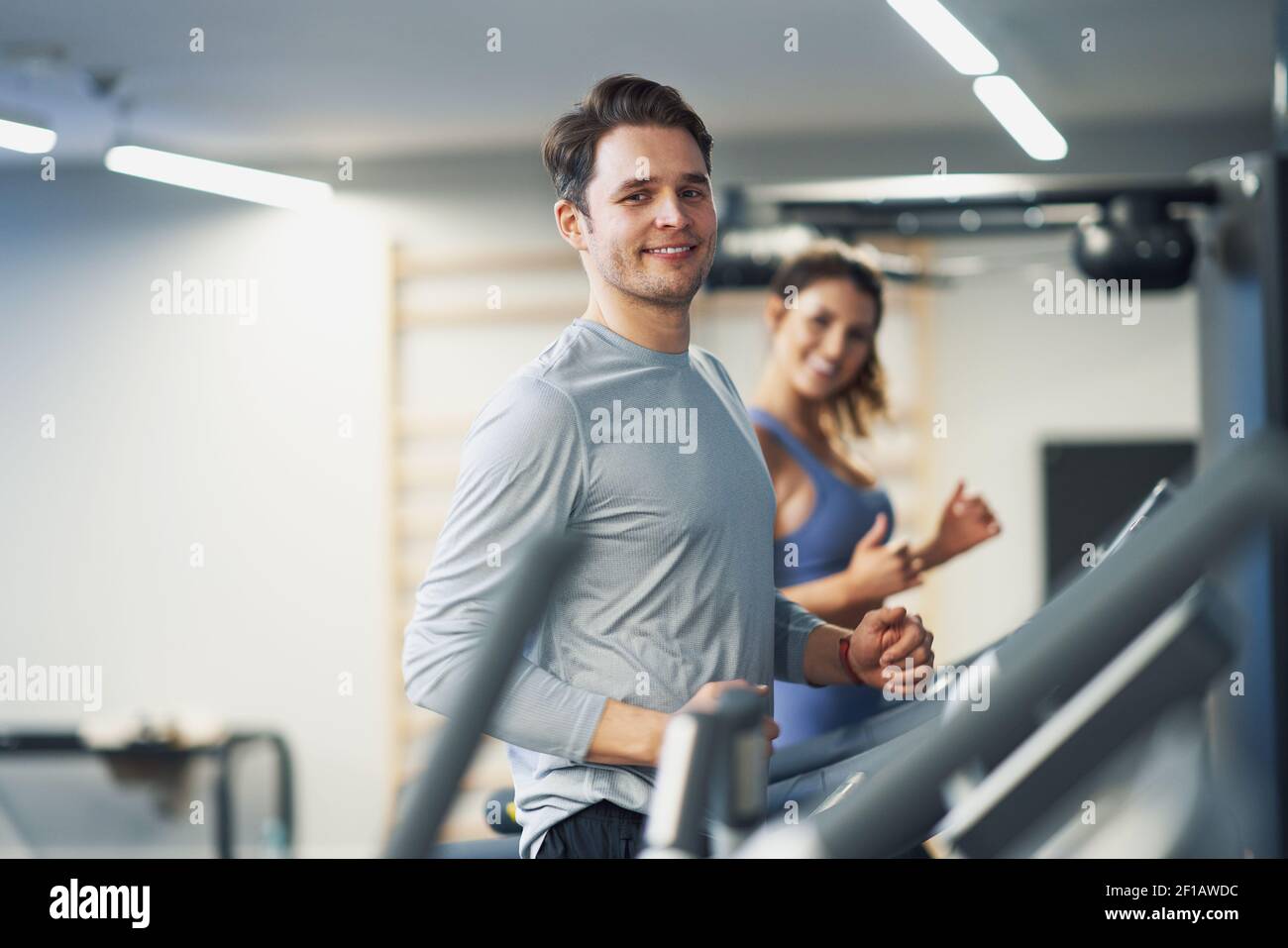 Two people working out on treadmill Stock Photo