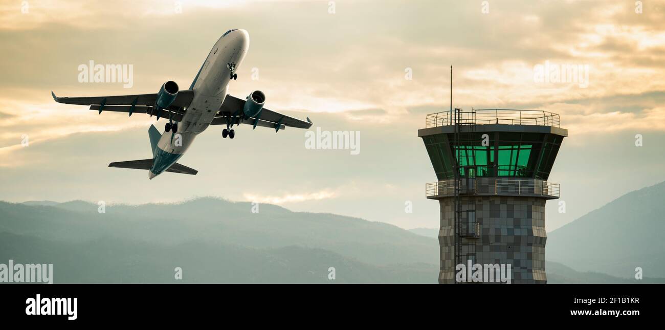 A plane landing at the airport against the background of sunset  Stock Photo