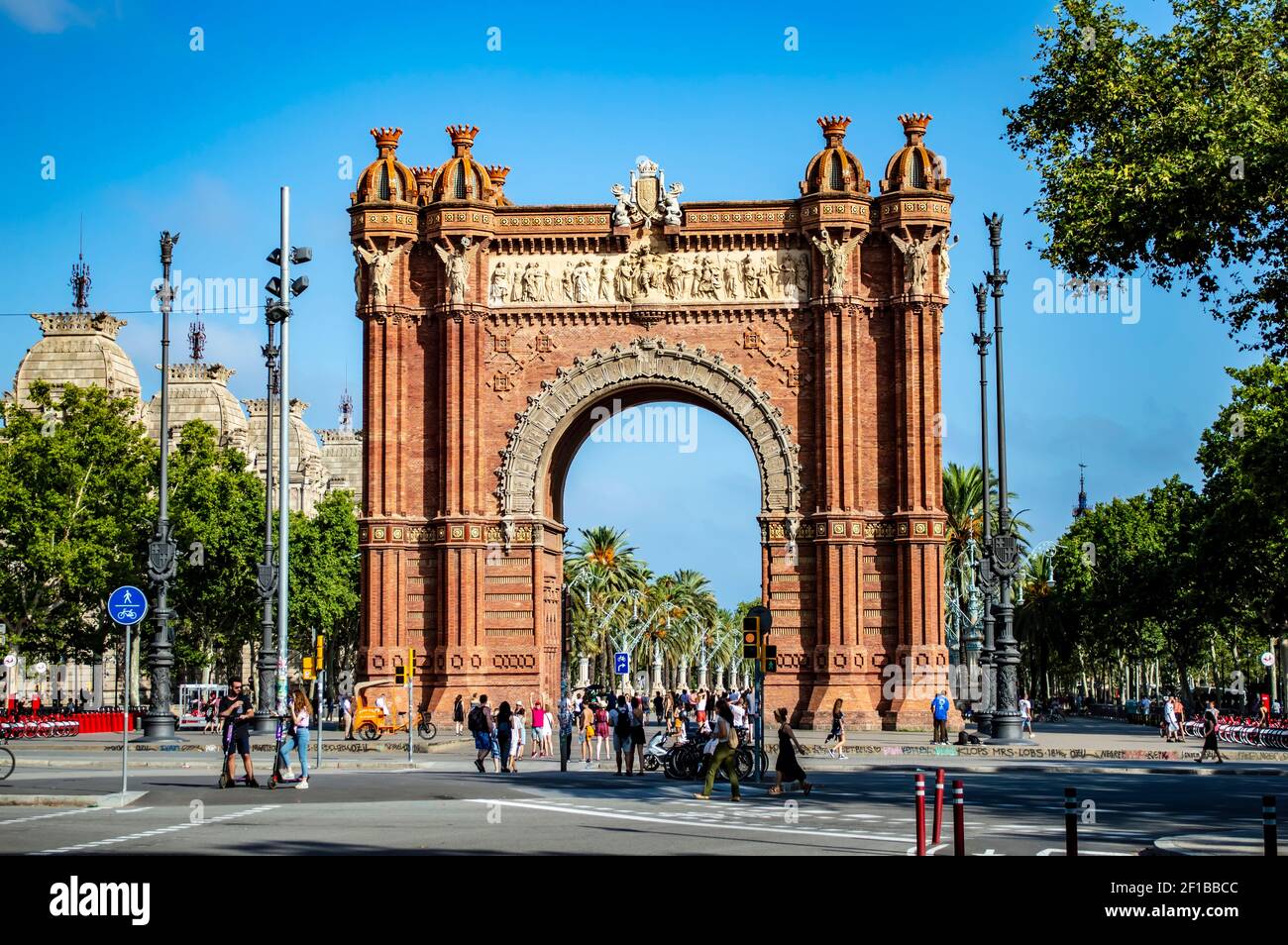 Barcelona, Spain - July 25, 2019: Tourists and locals walking through the Triumphal Arch of Barcelona in Spain Stock Photo