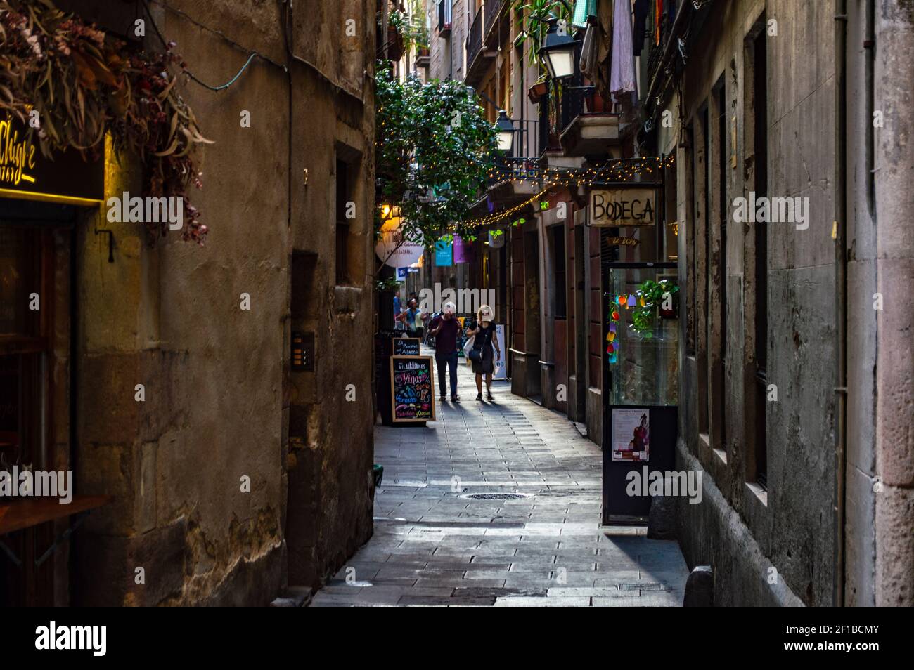 Barcelona, Spain - July 25, 2019: Lively street with lights, cafes and shops in the Roman quarter of the city of Barcelona, Spain Stock Photo