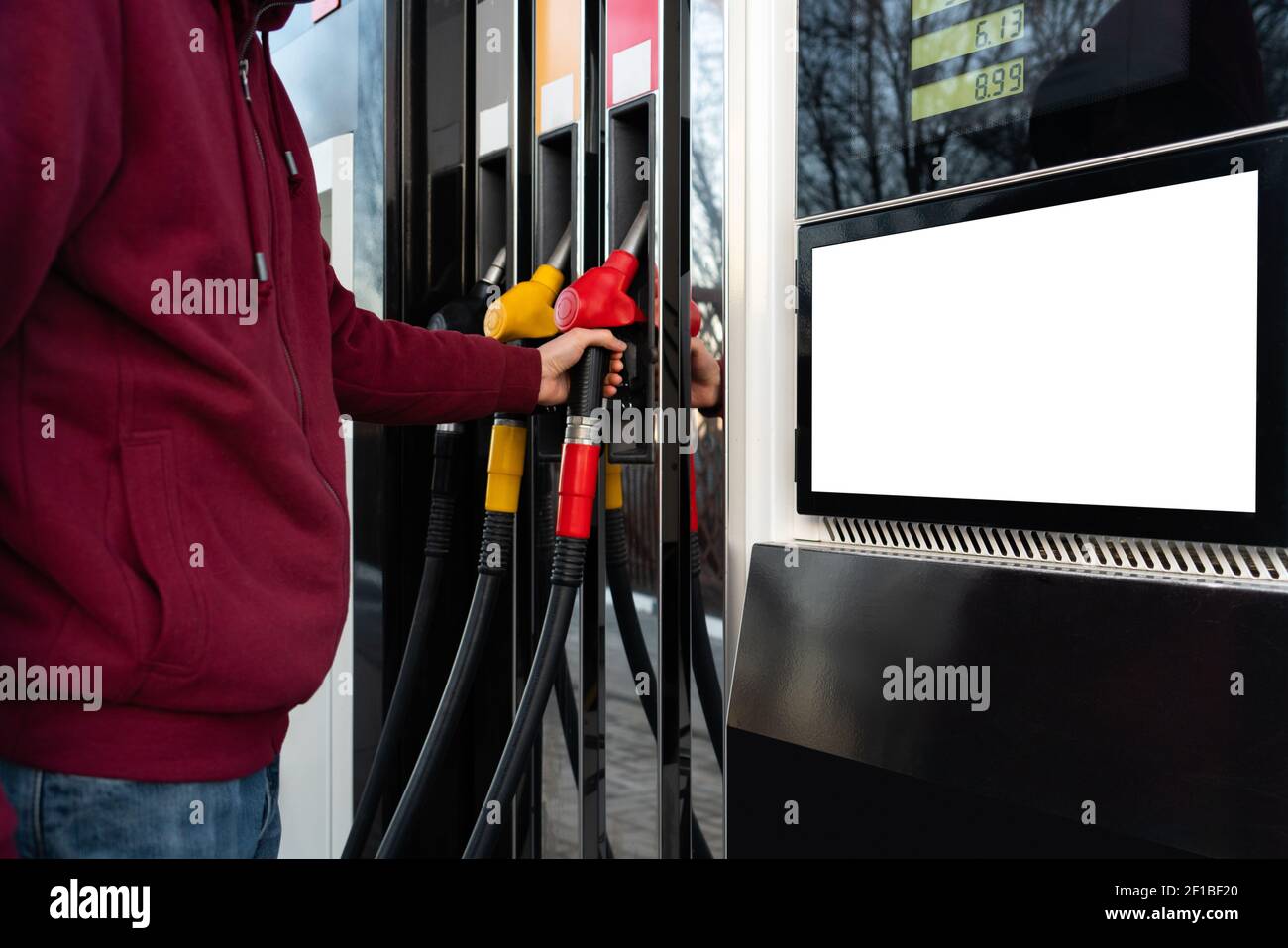 Self-service filling station. A man using a touchscreen  Stock Photo