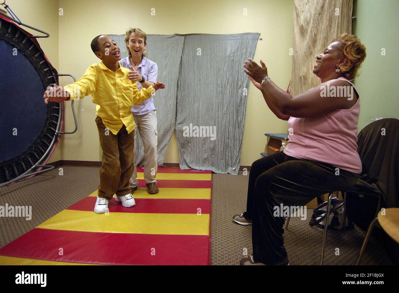 Therapist Amy Sturkey assists Chancellor Lee Adams as he walks towards
