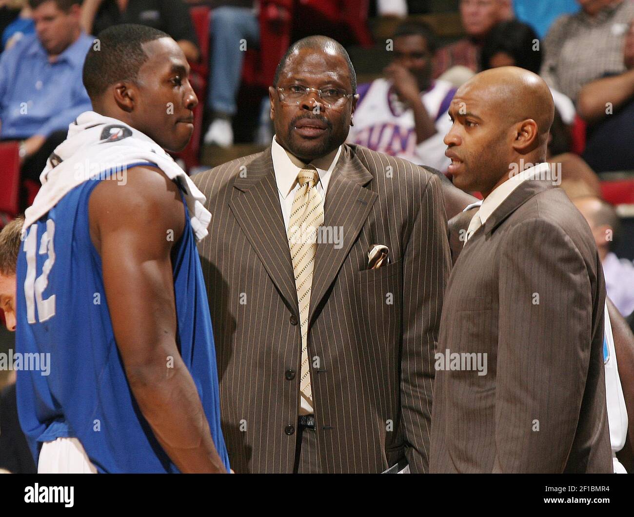 Orlando Magic center Dwight Howard, left, assistant coach Patrick Ewing,  middle, and guard Vince Carter, right, chat during a time out during their  game against the Phoenix Suns at Amway Arena on, image size:1300x1060