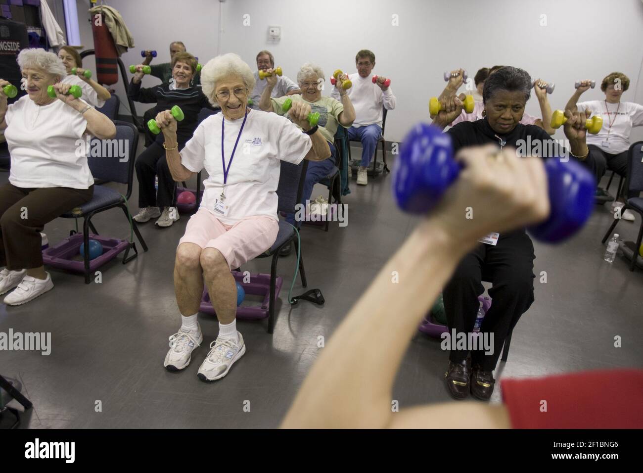 Silver Sneakers class member Josephine Ewasiuk, center, exercises at