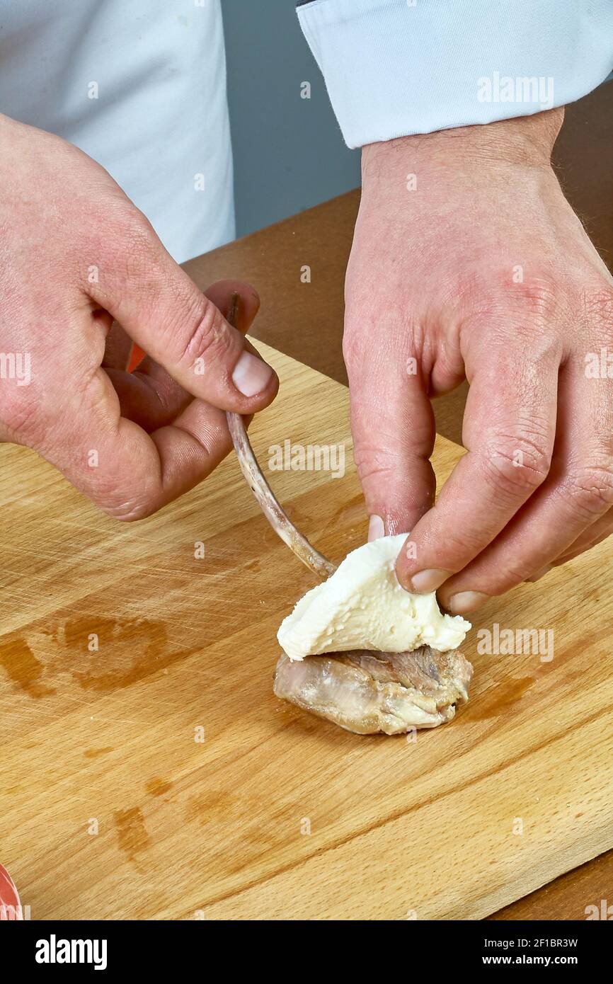 Cook prepares lamb ribs cooking process Stock Photo - Alamy