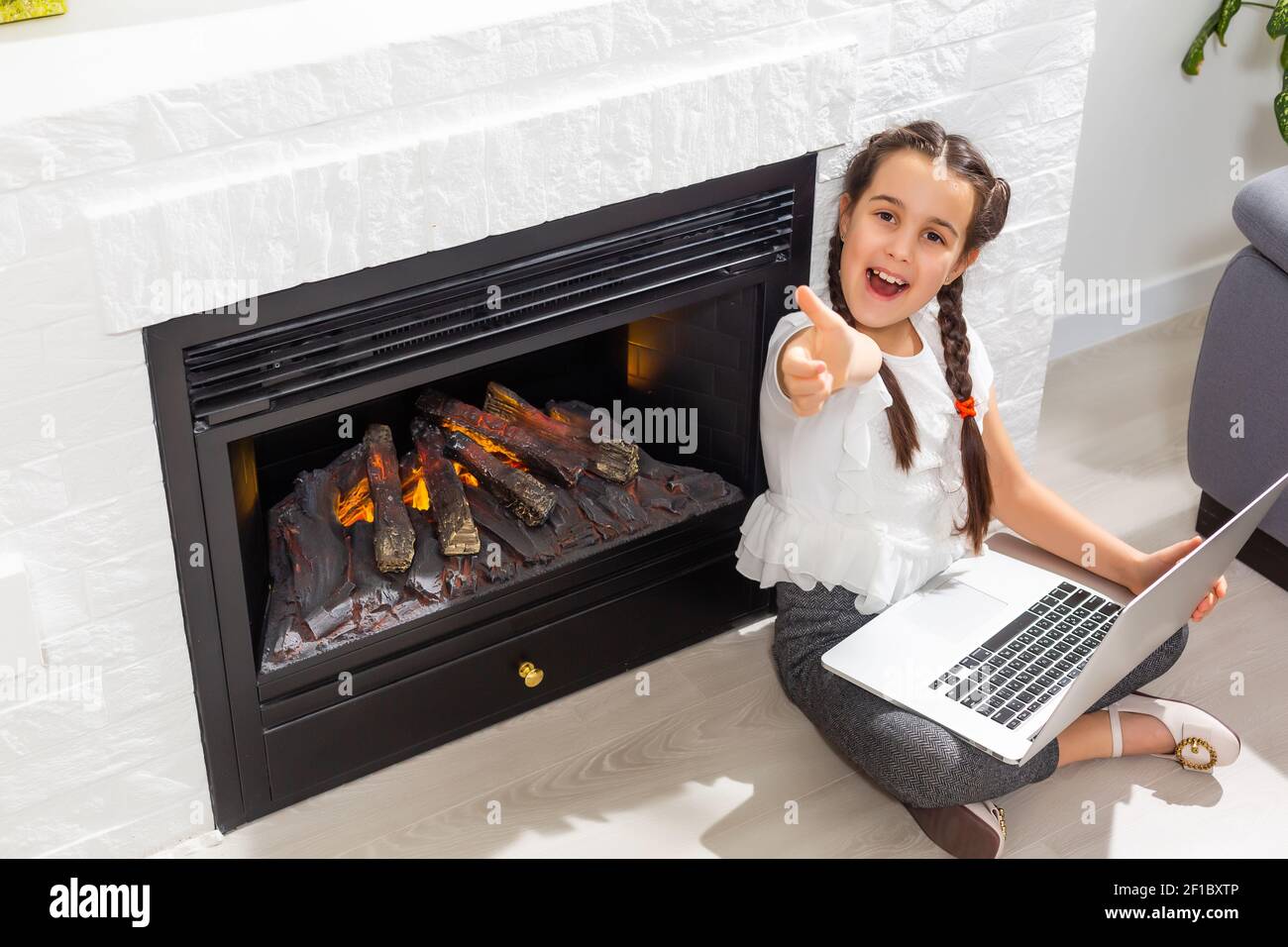 Kids distance learning. Cute little girl using laptop at home ...