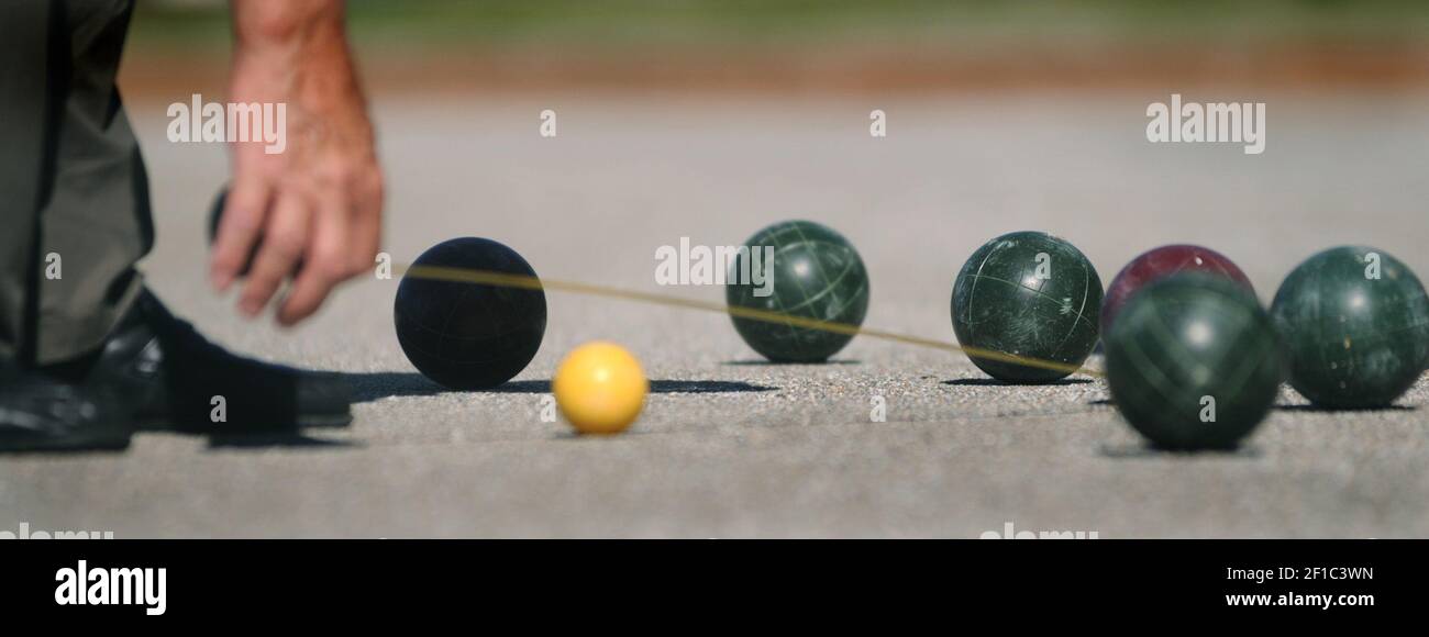 Aurelio Pattai measures the distance between balls while playing bocce