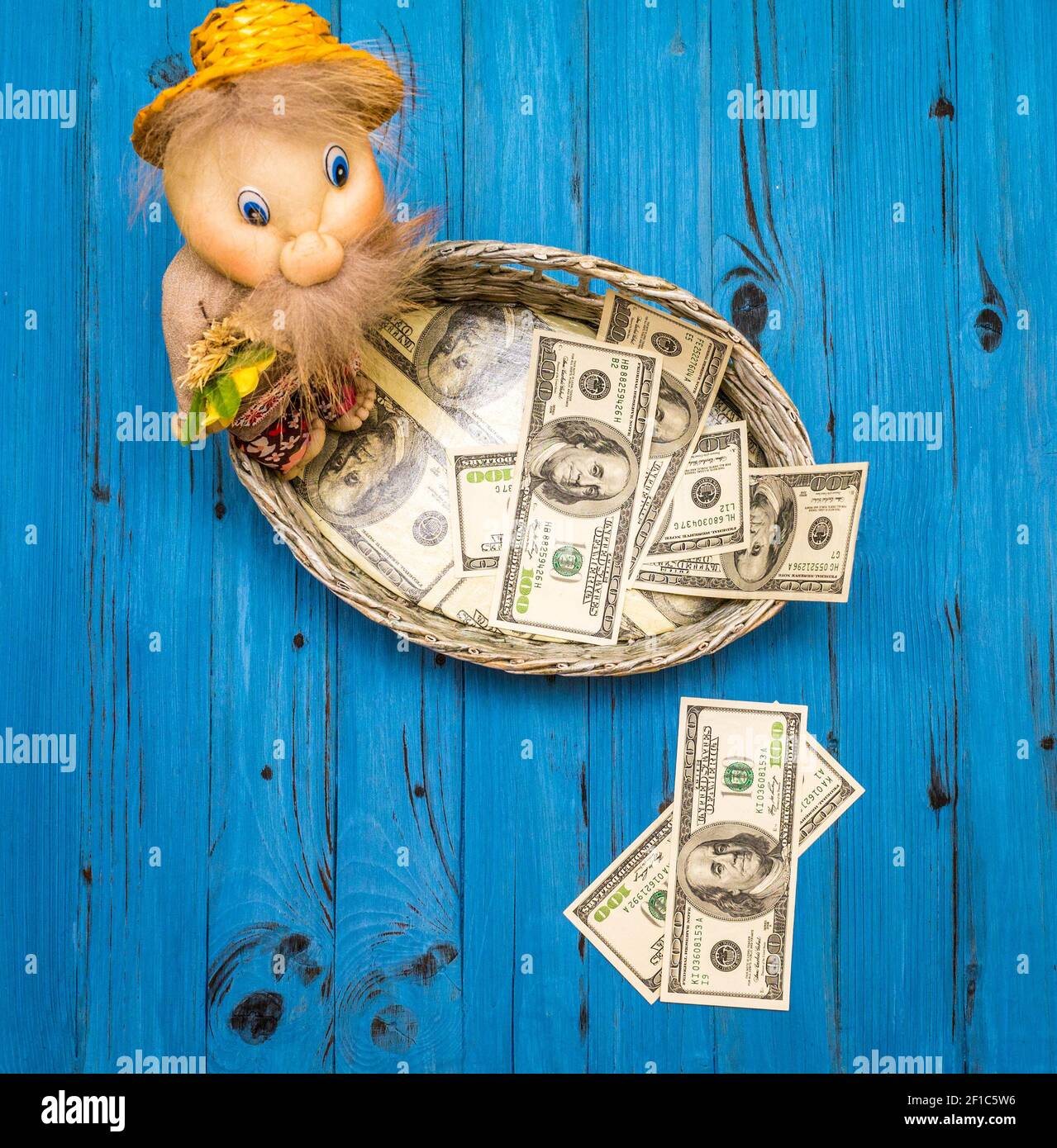 Dollar bills in a wicker basket Stock Photo Alamy