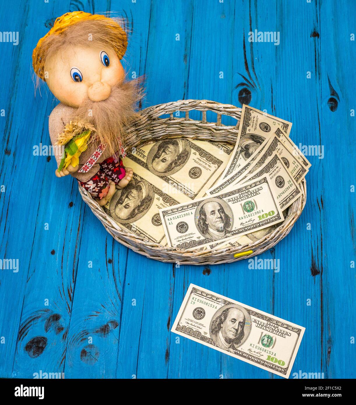 Dollar bills in a wicker basket Stock Photo Alamy