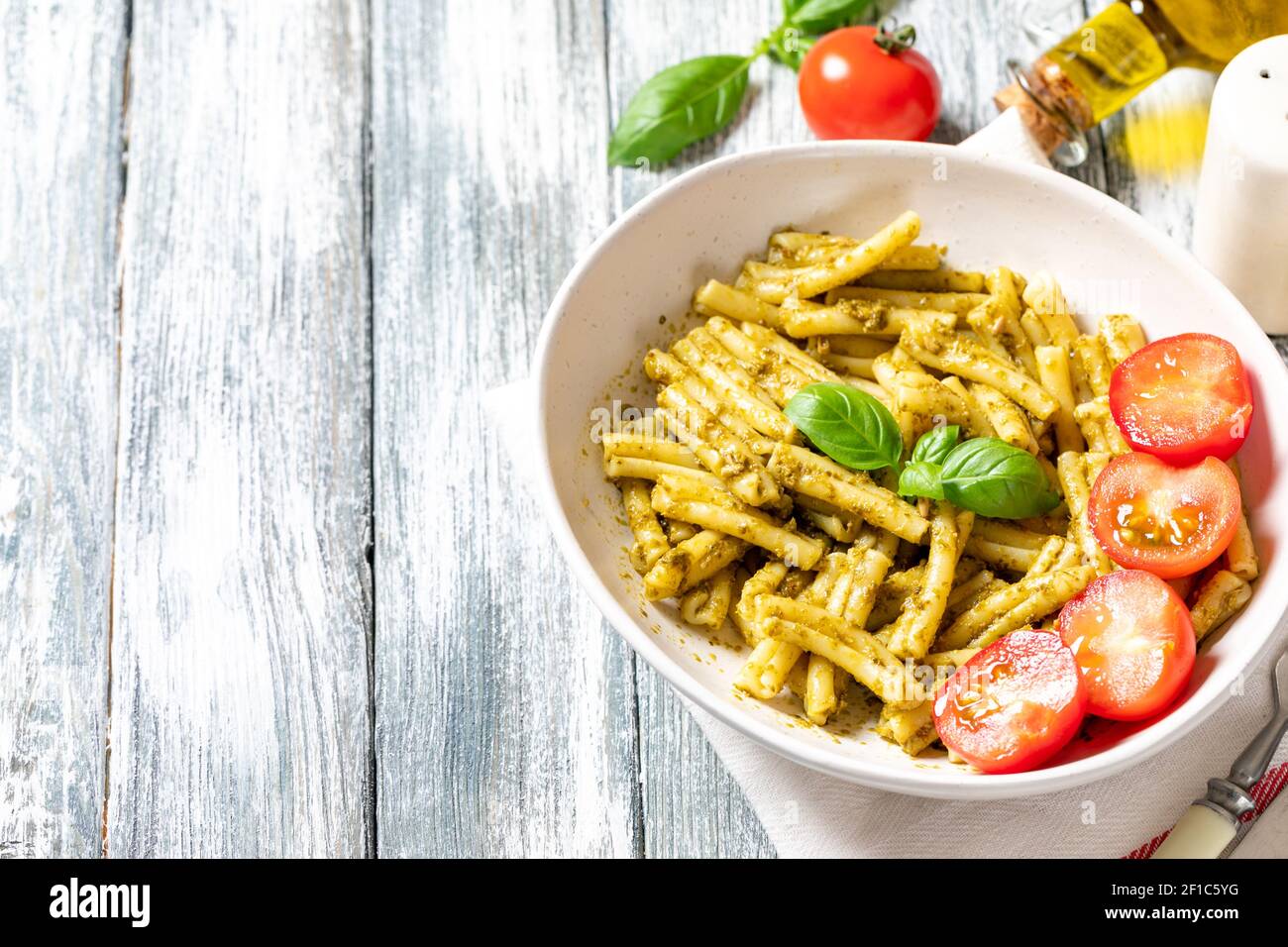 vegan pasta with homemade pesto sauce of basil, pine nuts and olive oil with cherry tomatoes. comfort food Stock Photo