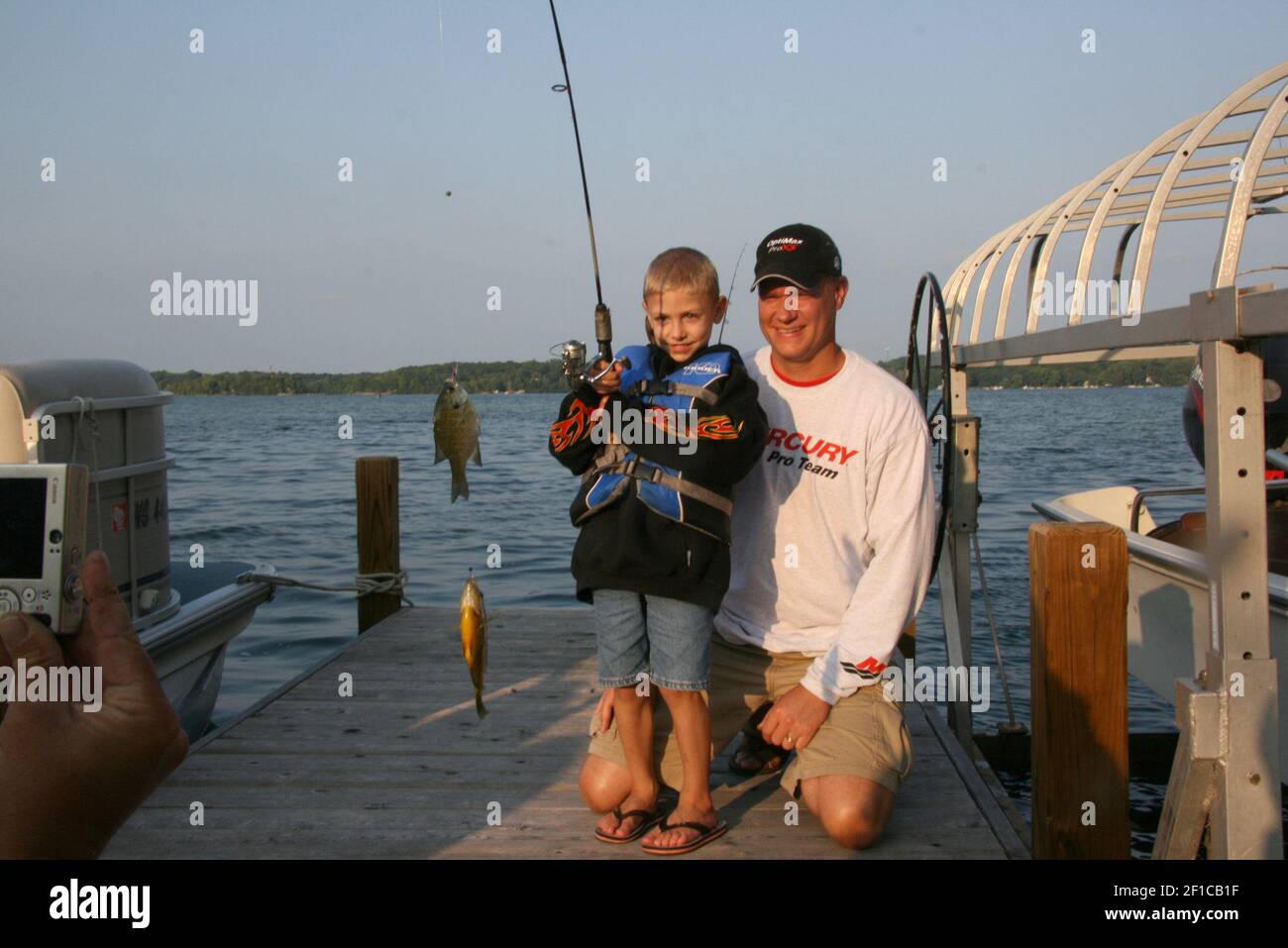 Bluegill are the most abundant panfish in Wisconsin and are a favorite species of young anglers like 6-year-old Nathaniel Luebke, shown here with his father Kevin on Pine Lake in Waukesha County. (Photo by Paul Smith/Milwaukee Journal Sentinel/MCT/Sipa USA) Stock Photo