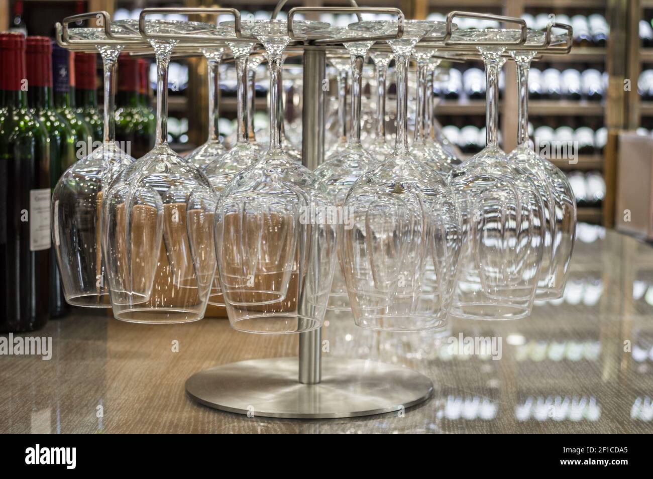 Close up empty wine glasses hanging upside down in a wine store Stock Photo