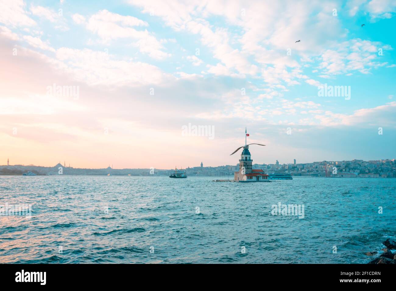 Maiden's Tower and Seagulls at sunset. Kiz Kulesi at sunset in Istanbul. Istanbul background photo. Travel to Istanbul. Sunset and cityscape of Istanb Stock Photo