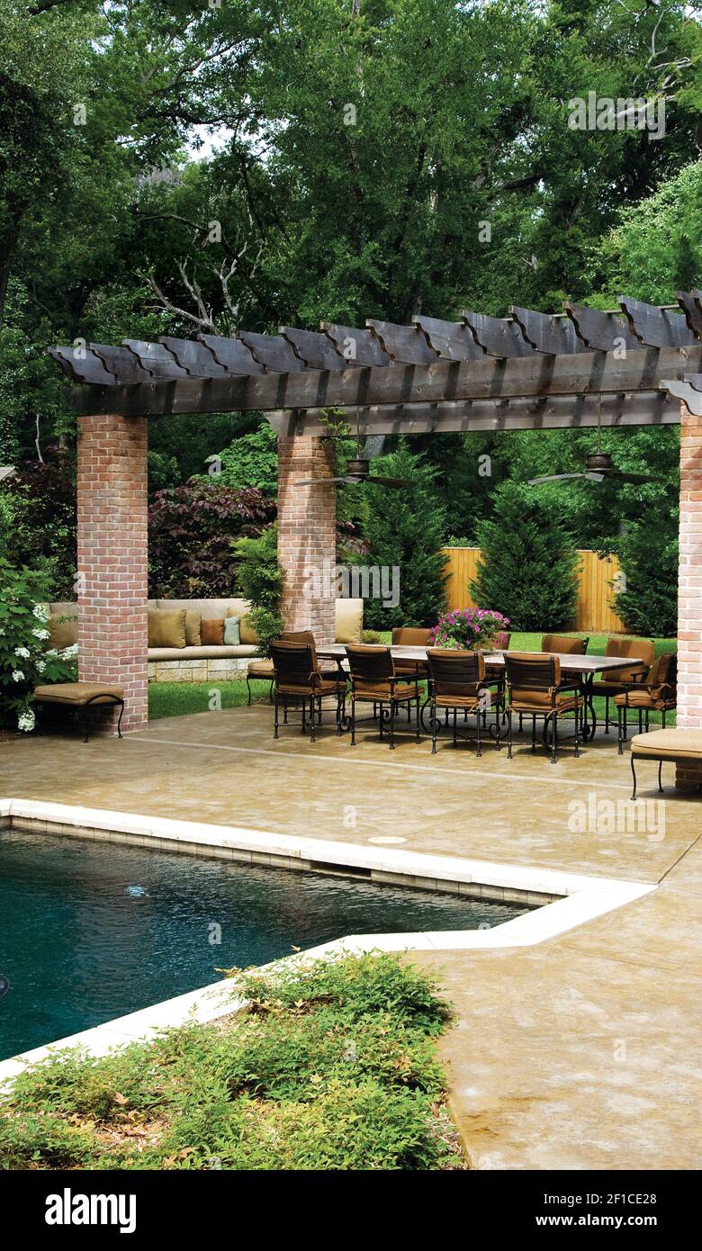 Elizabeth Webb and her husband, Jim, knew that they wanted an outdoor patio, a kitchen and a place for entertaining, and they wanted to update their pool, too. Landscape designer Brenda Pender gave them a reconfigured pool with patterned concrete around it and a pergola shading a large area for entertaining, plus a stone 'couch' with custom cushions and many of their other requested features. (Photo by Ross Hailey/Fort Worth Star-Telegram/MCT/Sipa USA) Stock Photo