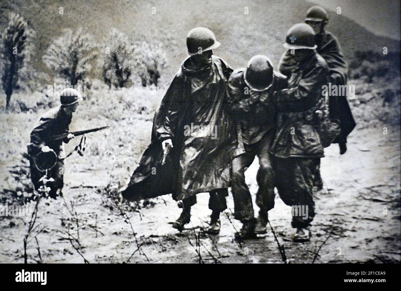 This is a copy photograph of Father Emil Kapaun, left, helping a