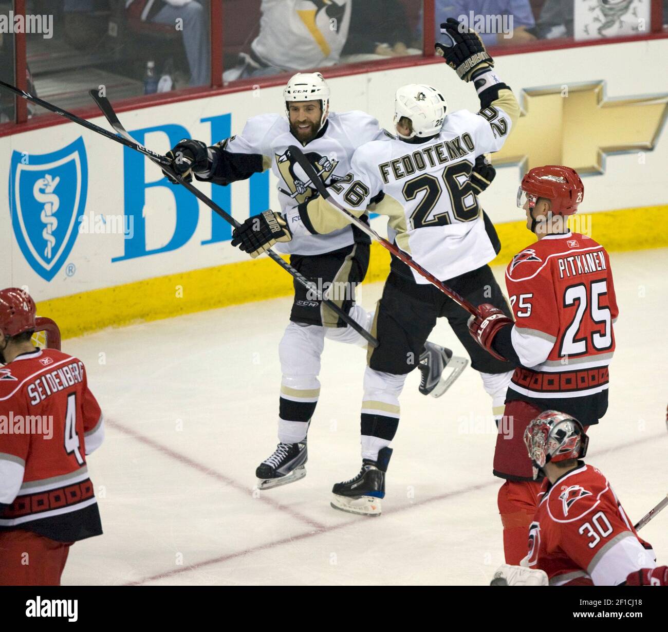 Pittsburgh Penguins' Ruslan Fedotenko (26) celebrates his first period goal  with teammate Maxime Talbot (25) in Game 4 of the NHL Eastern Conference  finals at the RBC Center in Raleigh, North Carolina