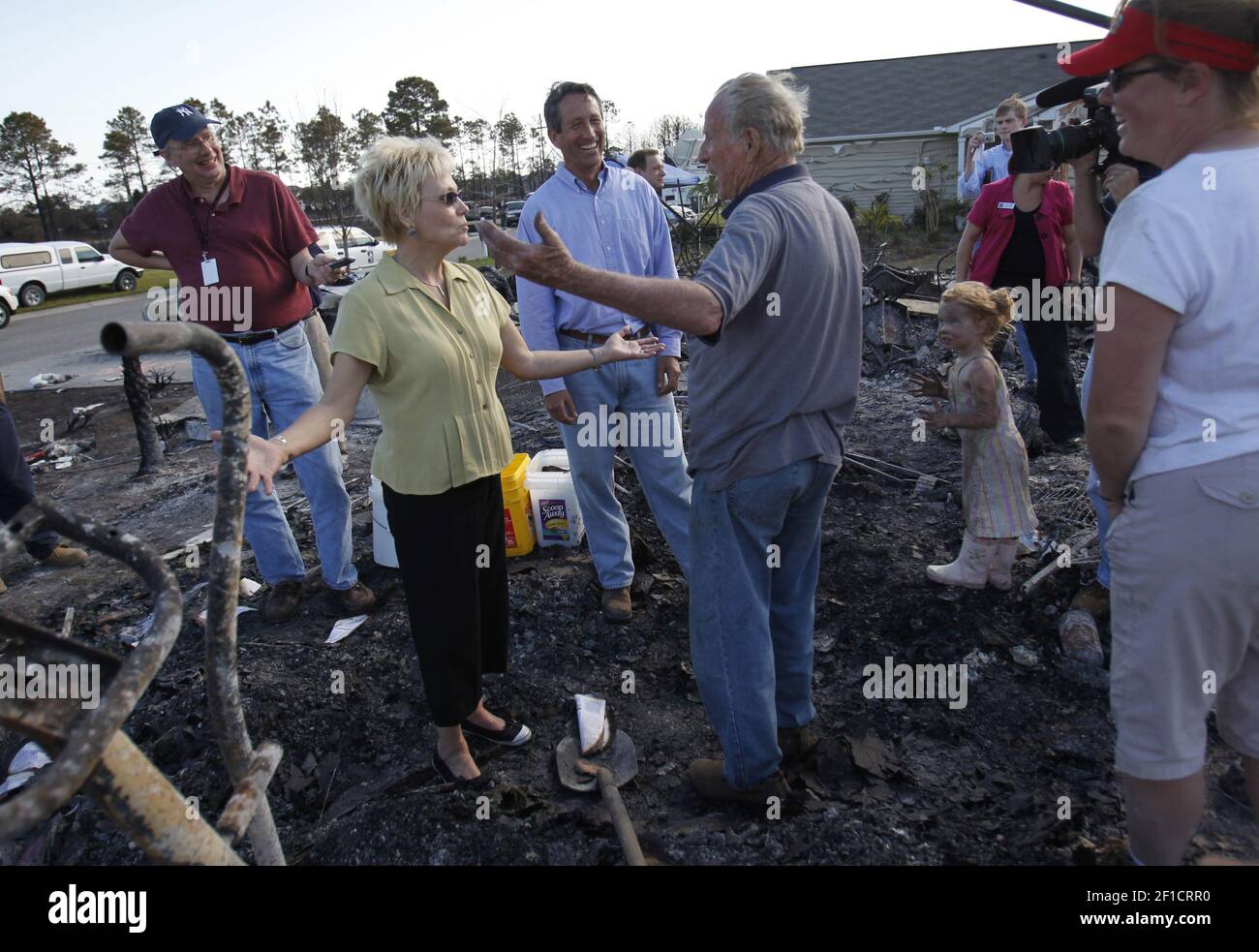 North Myrtle Beach mayor Marilyn Hatley (center left) and South Carolina  Gov. Mark Sanford (center) visit fire victims including Bob Portteus  (center right) in North Myrtle Beach, South Carolina, on Friday, April