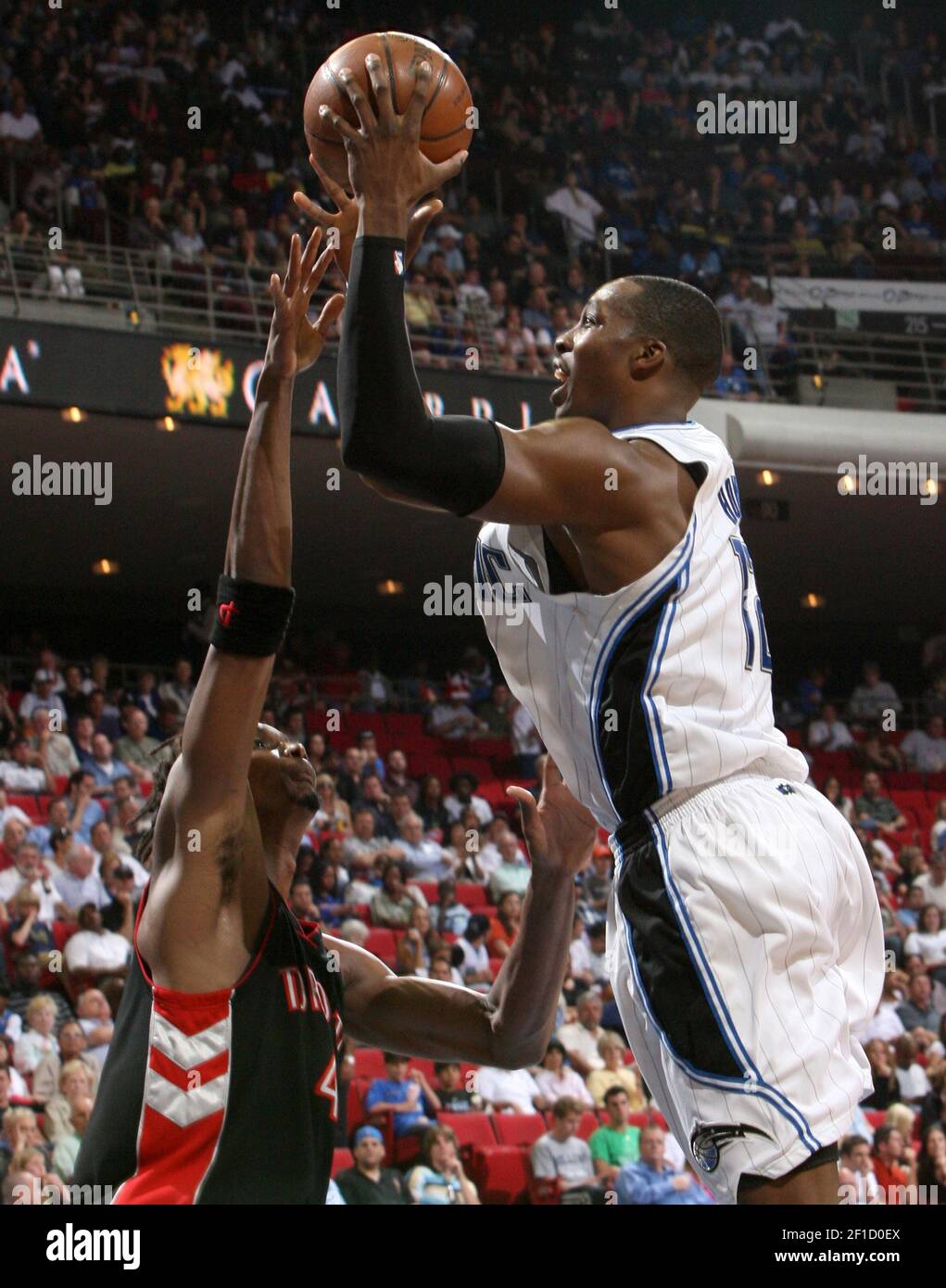 Toronto Raptors forward Chris Bosh, left gets his hand in the face of  Orlando Magic center Dwight Howard during game action at Amway Arena in  Orlando, Florida, Wednesday, April 1, 2009. The