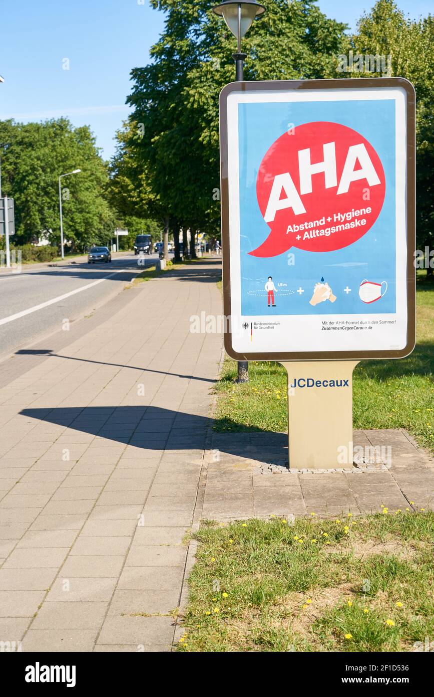 WARNEMUENDE, Germany, July 2020: Billdboard with German AHA (Abstand, Hygiene, Alltagsmaske) rules (meaning distancing, hygiene, face mask) against sp Stock Photo