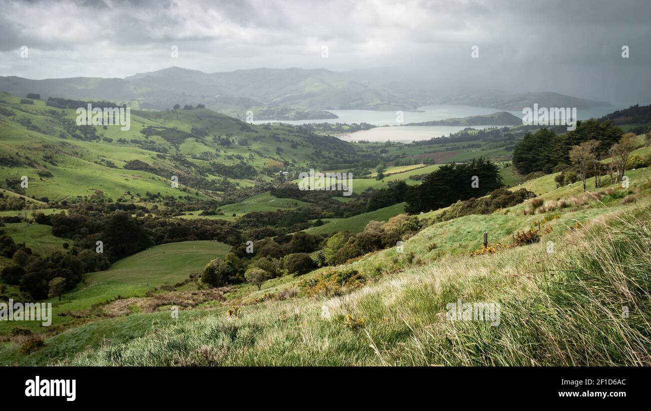 Storm approaching a valley with green rolling hills, storm approaching a valley with green rolling hills Stock Photo