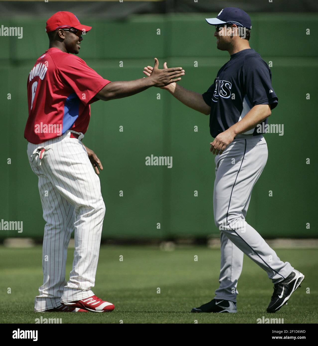 Former Philadelphia Phillies Pat Burrell (right, now of the Rays) and  Phillies' first baseman Ryan Howard (left) greet each other before the  start of a spring training game between the Tampa Bay