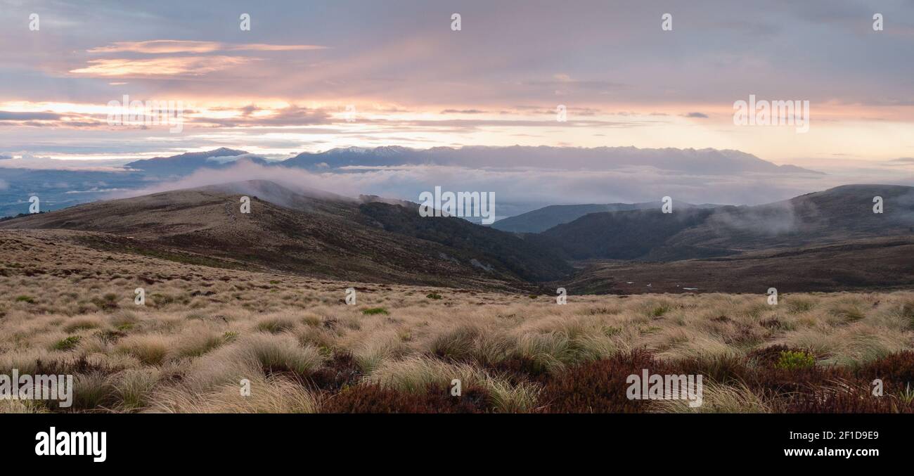 Foggy sunrise over the valleys on Kepler Track (wide shot), Fiordland National Park, New Zealand Stock Photo