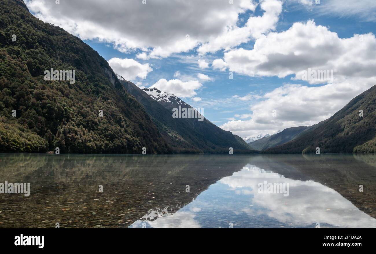 Reflections on a lake during sunny day. Photo taken at lake Gunn, Fiordland National Park, New Zealand Stock Photo
