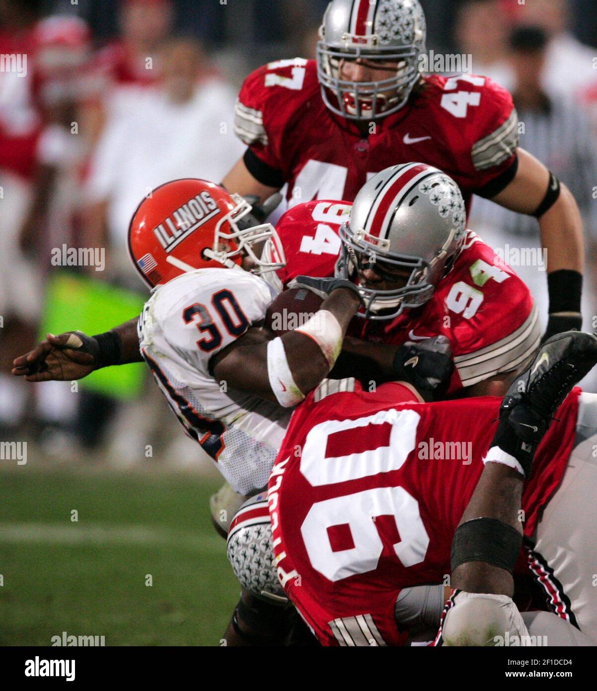 KRT SPORTS STORY SLUGGED: FBC-OHIOST-ILLINOIS KRT PHOTOGRAPH BY MIKE  CARDEW/AKRON BEACON JOURNAL (November 5) COLUMBUS, OH-- Illinois' Pierre  Thomas (30) is brought down by Ohio State's Quinn Pitcock (90), Marcus  Green (94)