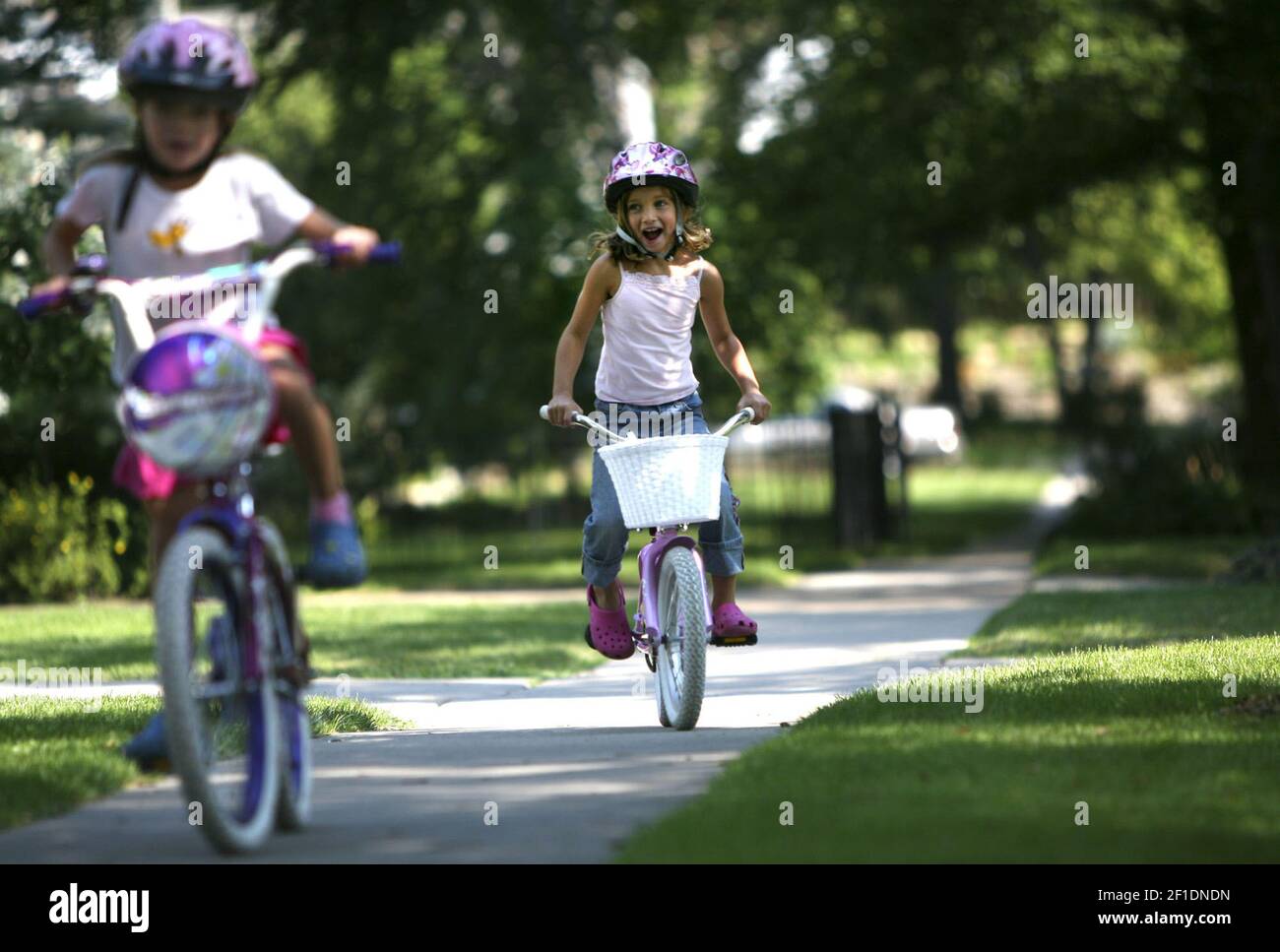 Neighborhood children ride bikes on the sidewalk in front of their homes in Edina, Minn. A plan to add more sidewalks in the community has sparked a fight. (Photo by Renee Jones Schneider/Minneapolis Star Tribune/TNS/Sipa USA) Stock Photo