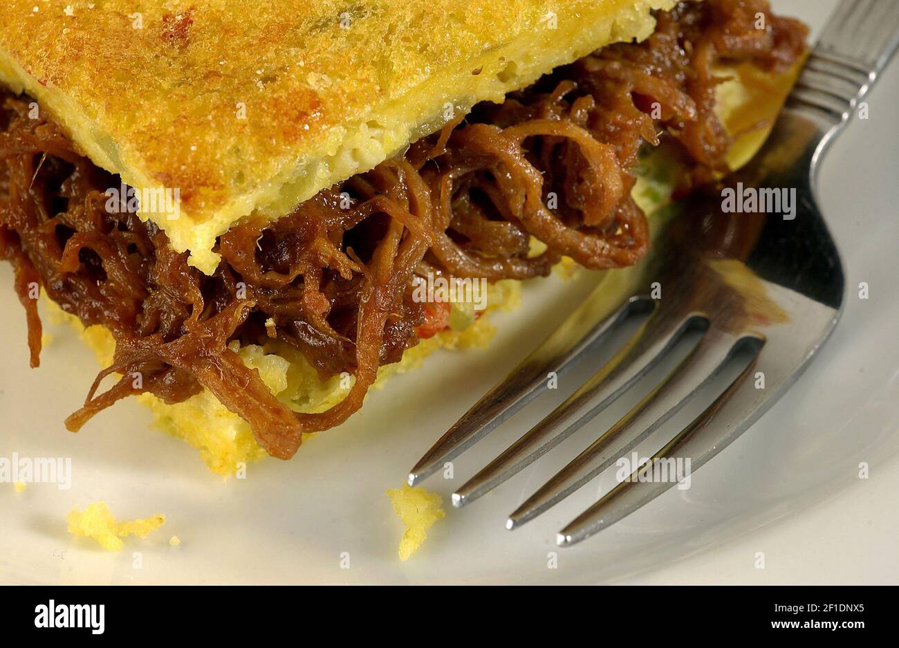 Barbequed pork is sandwiched between layers of corn bread that is bolstered with cheddar, corn kernels and jalapeno. (Photo by James F. Quinn/Chicago Tribune/TNS) *** Please Use Credit from Credit Field *** Stock Photo