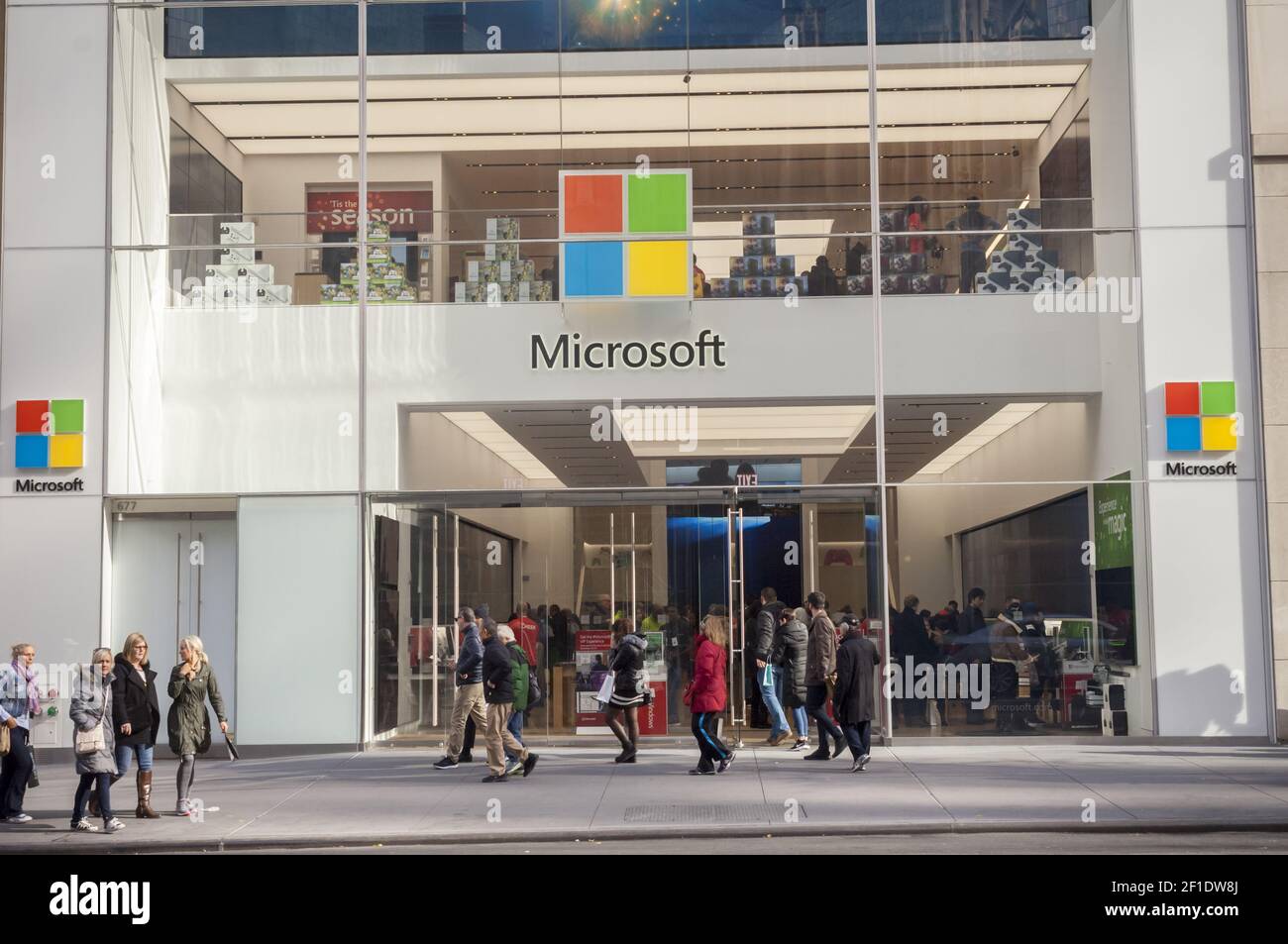 Crowds of shoppers pass the Microsoft store on Fifth Avenue in Midtown