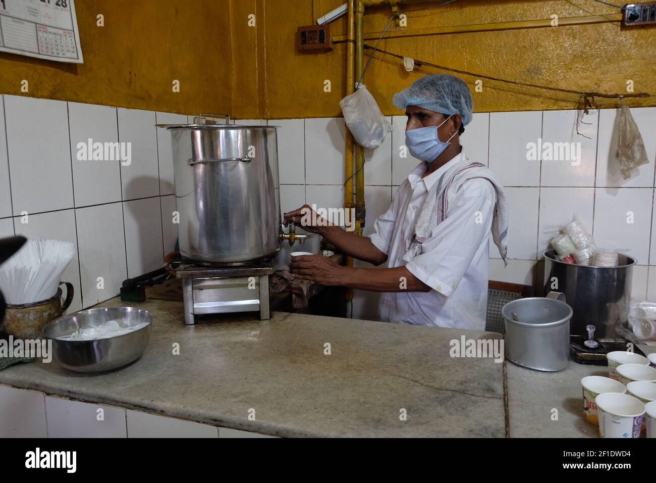 A staff prepare coffee for the customers inside the Kitchen of Coffee House.The iconic Indian Coffee House is set to open with several crucial norms of COVID-19 from today,Thursday, July 2, 2020. After a gap off over three months due to Coronavirus Pandemic. (Photo by Satyajit Shaw/Pacific Press/Sipa USA) Stock Photo