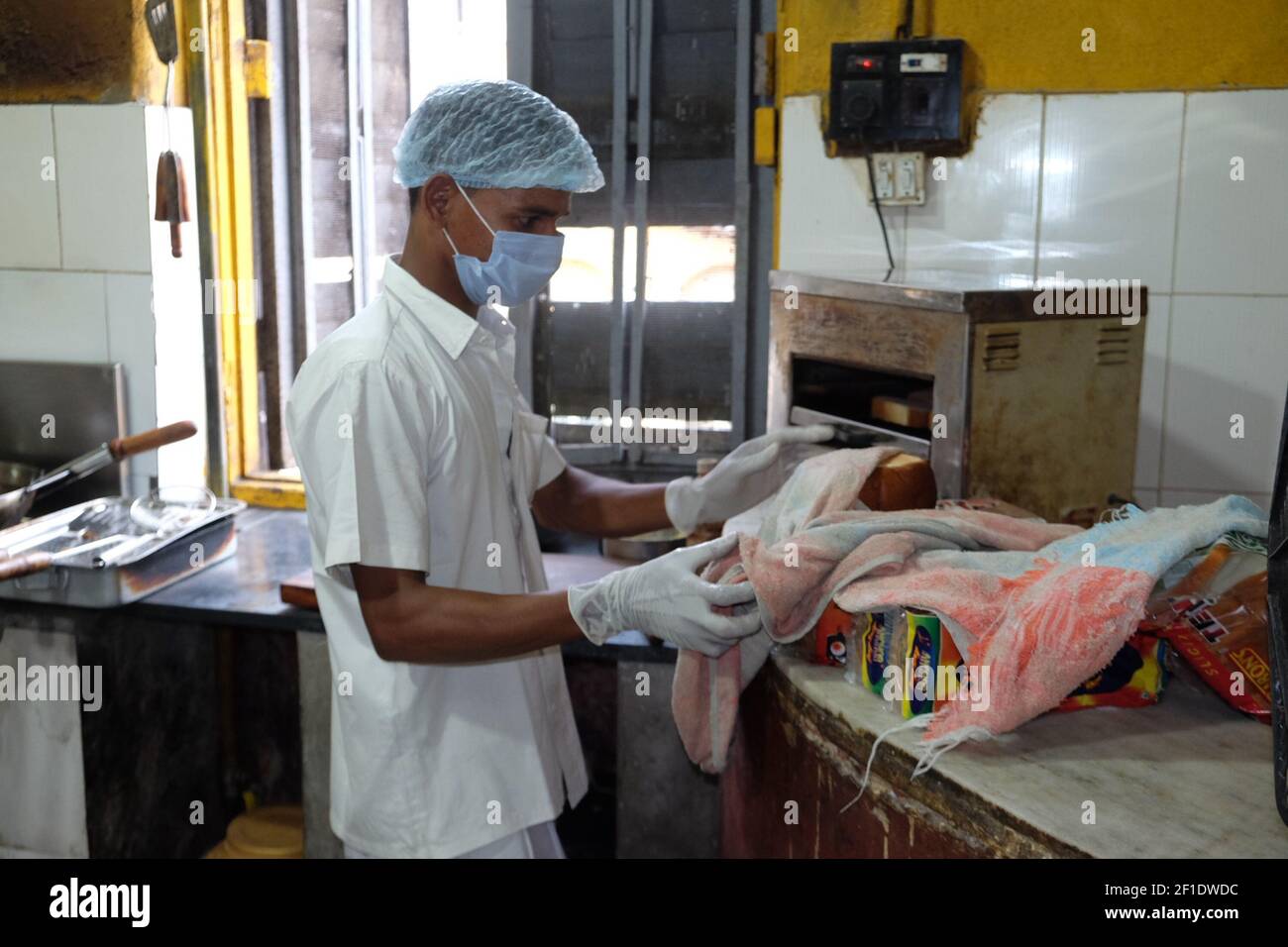 A staff prepare food for the customers inside the Kitchen of Coffee House.The iconic Indian Coffee House is set to open with several crucial norms of COVID-19 from today,Thursday, July 2, 2020. After a gap off over three months due to Coronavirus Pandemic. (Photo by Satyajit Shaw/Pacific Press/Sipa USA) Stock Photo