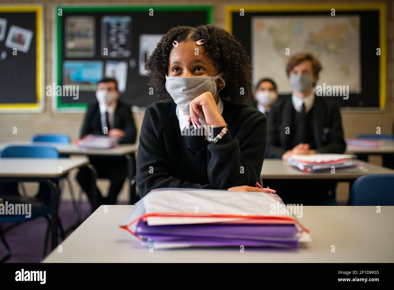 Year 11 students wearing facemasks in the classroom at Oasis Academy Shirley Park in Croydon, south London, as pupils in England return to school for the first time in two months as part of the first stage of lockdown easing. Picture date: Monday March 8, 2021. Stock Photo