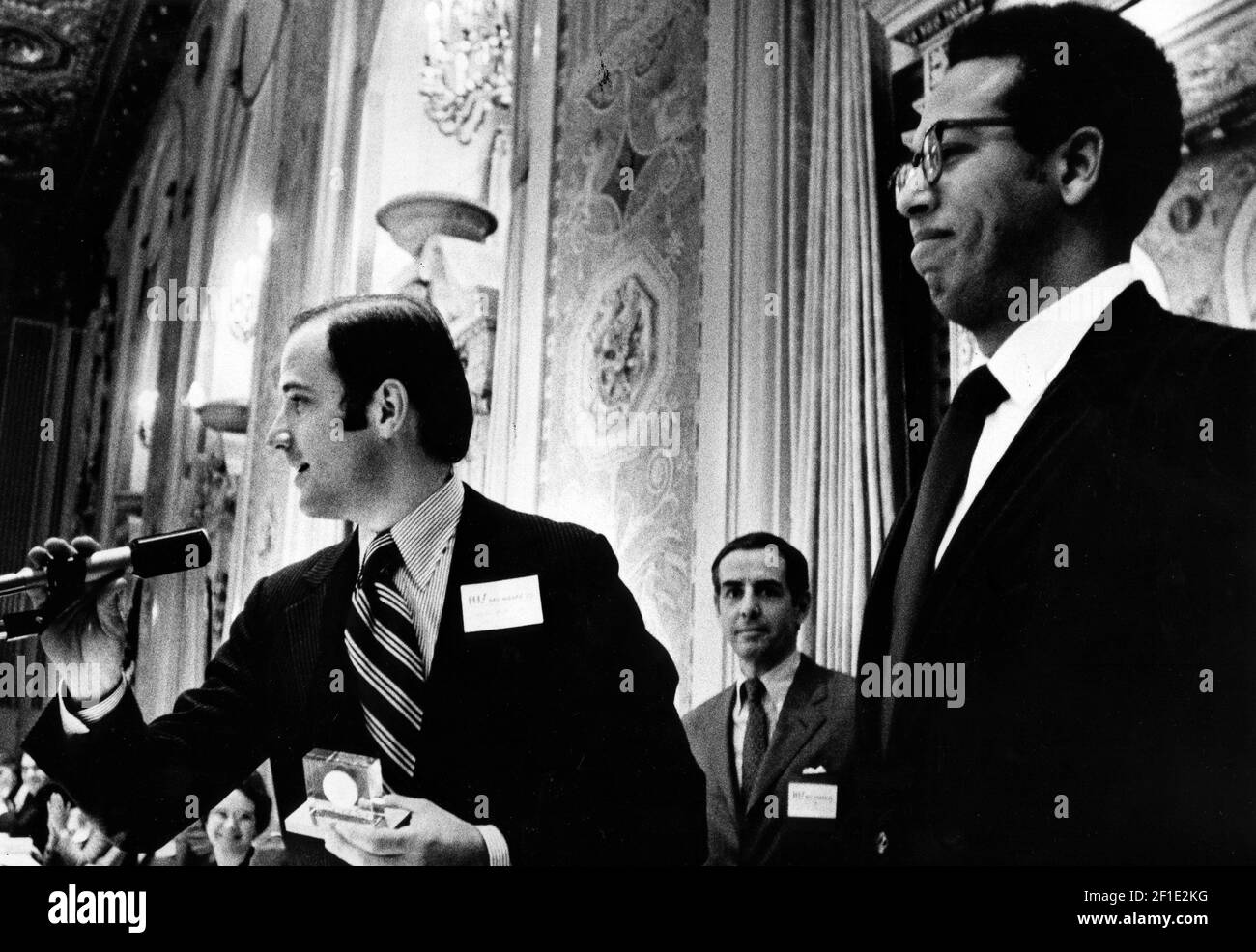 Feb 16, 1973; Wilmington, DE, USA; U.S. Sen. Joseph R. Biden Jr. D-Del. prepares to present the Big Brother of the Year Award to Capt. Albert E. Lassiter (right) of Dover in recognition of his 20 months of work with a fatherless 10-year-old disadvantaged boy. Biden and Wilmington Mayor Thomas C. Maloney told the Big Brothers organization that their burden is likely to increase because of President Nixon's cuts in federally funded social services programs. Dan Dudon (center), president of Big Brothers of Delaware, Inc., reported that the eight-year-old organization now provides adult guidance t Stock Photo