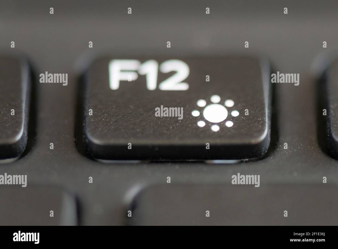 F12 and increase brightness key on a laptop keyboard Stock Photo - Alamy