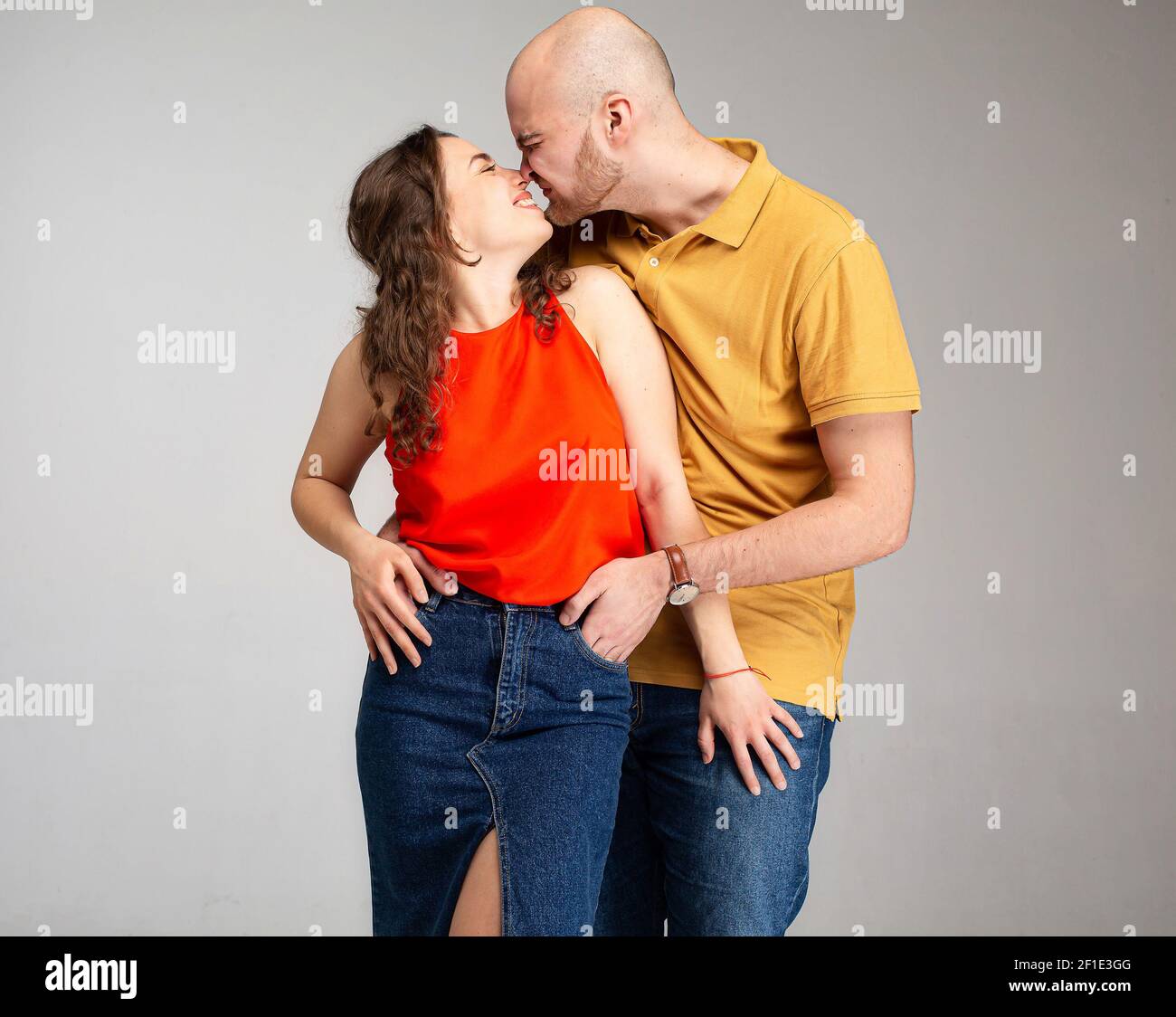 Young white european couple kissing isolated on gray Stock Photo