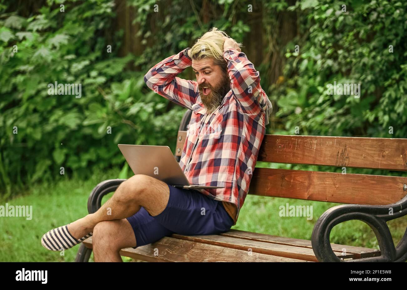 Fresh air. Mobile internet. Online shopping. Agile business. Bearded guy sit bench park nature background. Work and relax. Working online. Hipster inspired work in park. Modern laptop. Remote job. Stock Photo