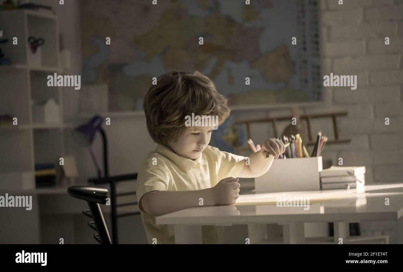 Cute child little boy drawing picture on table Stock Photo - Alamy