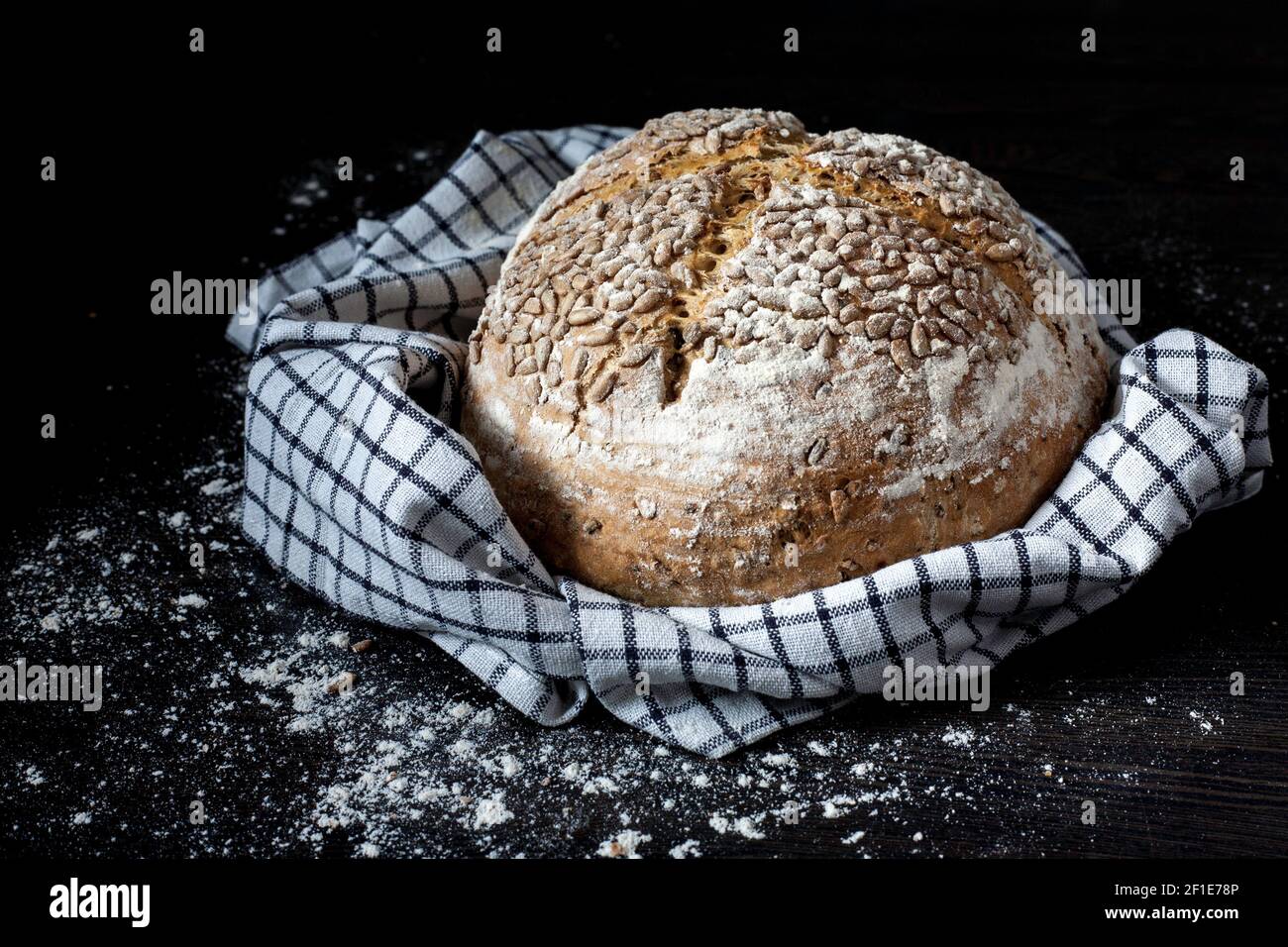 Freshly baked bread in tea towel Stock Photo