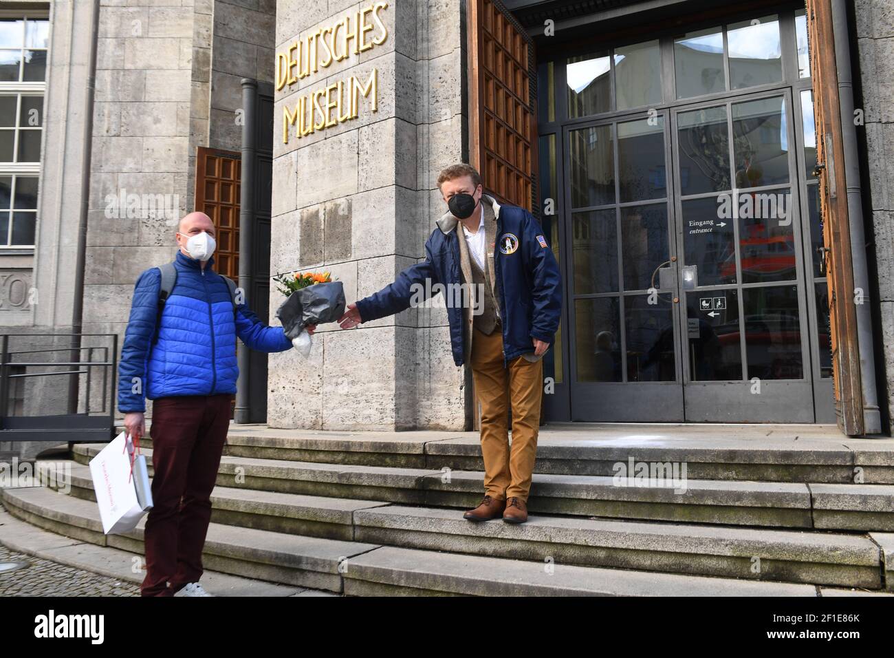 Munich, Germany. 08th Mar, 2021. The General Director of the Deutsches Museum, Wolfgang M. Heckl (r), welcomes the first visitor after the lockdown, Bernd Daubner, in front of the entrance to the Deutsches Museum. The latest relaxations of the measures against Corona include, for example, openings of museums. Credit: Felix Hörhager/dpa/Alamy Live News Stock Photo