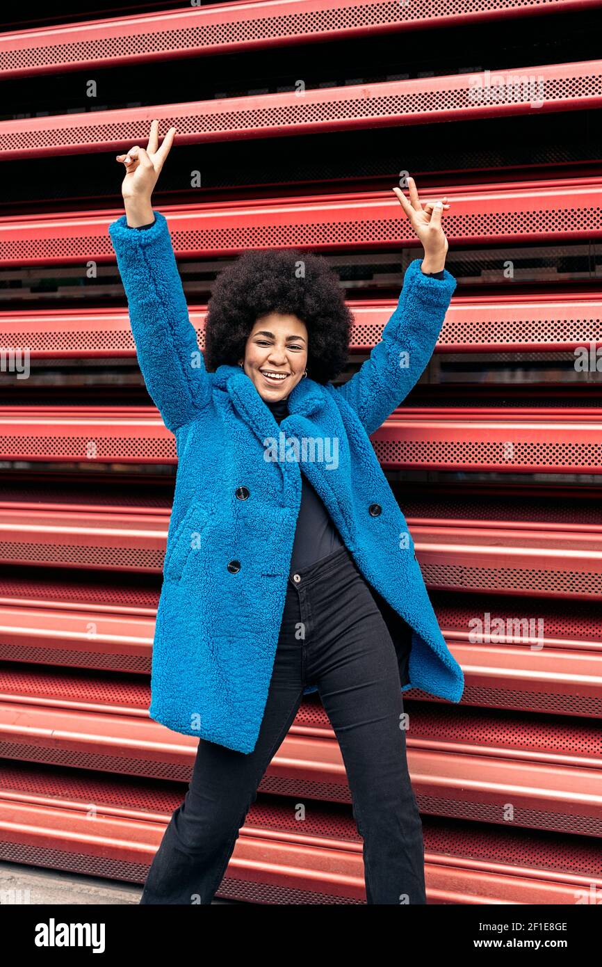 Stock photo of cheerful african american girl posing and looking at ...