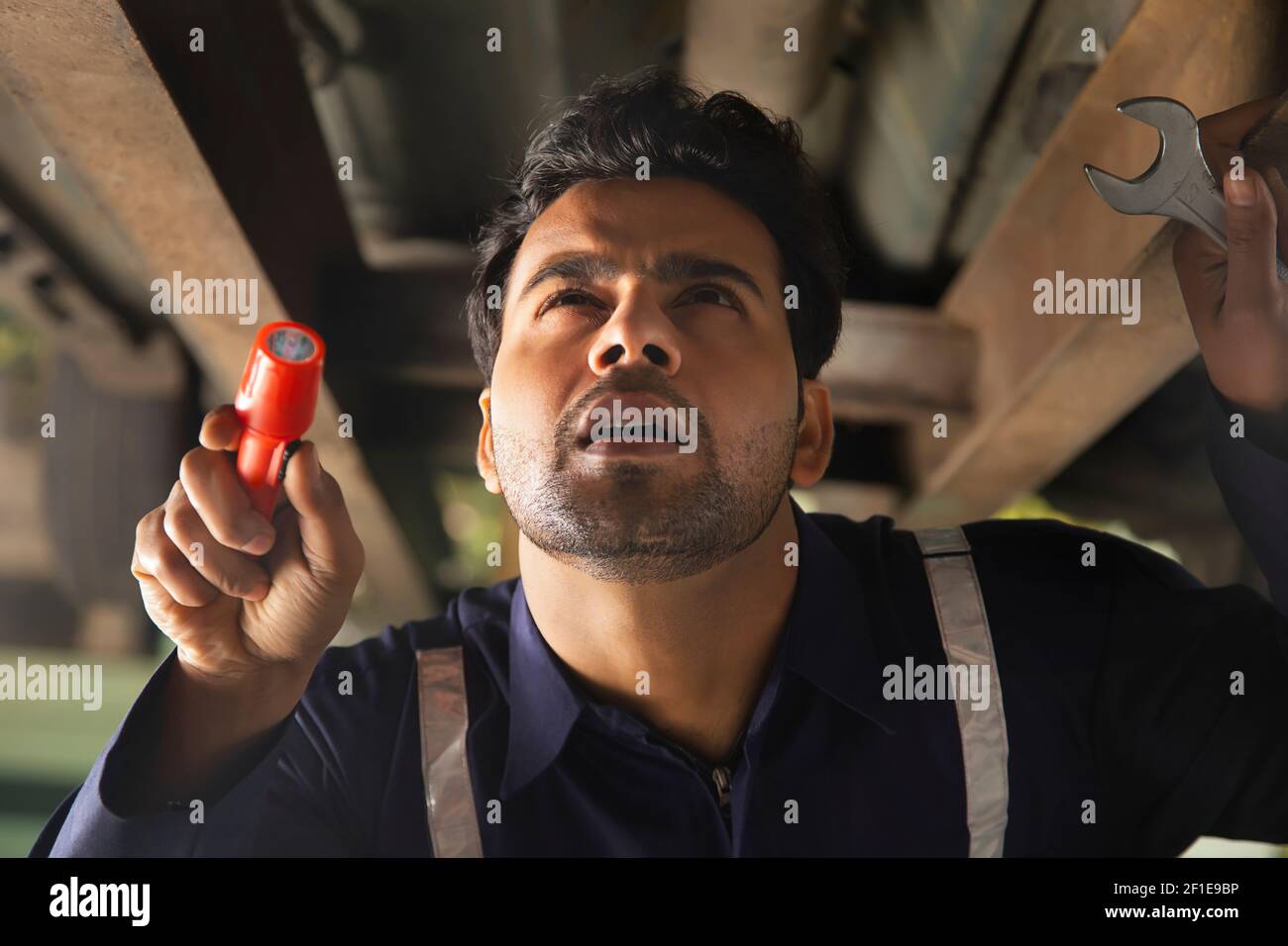 Mechanic checking the lower part of the car Stock Photo